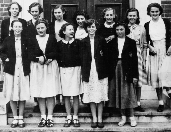 East Barnet School history archive of 12 female students in dresses and uniform from the 1940s.