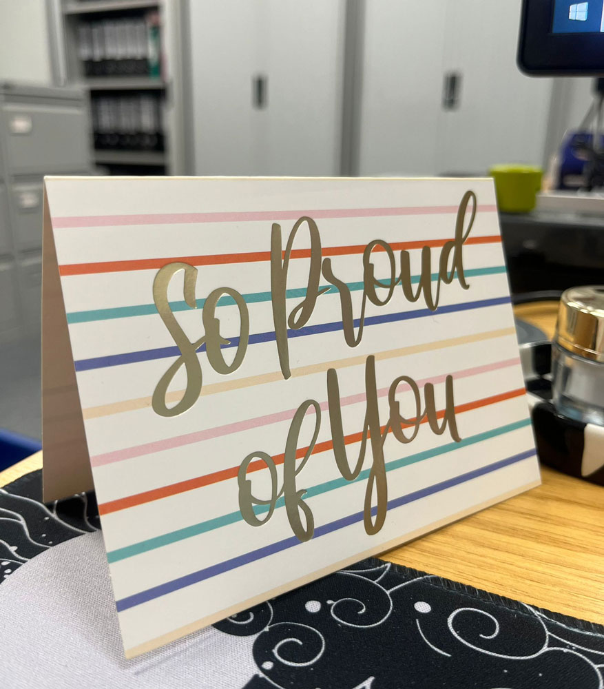a greeting card that says so proud of you on the front
