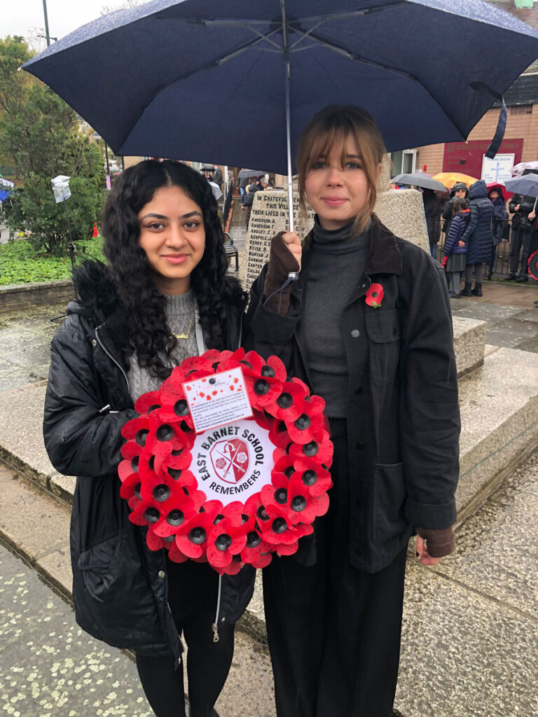 two students with the east barnet school wreath for remembrance sunday