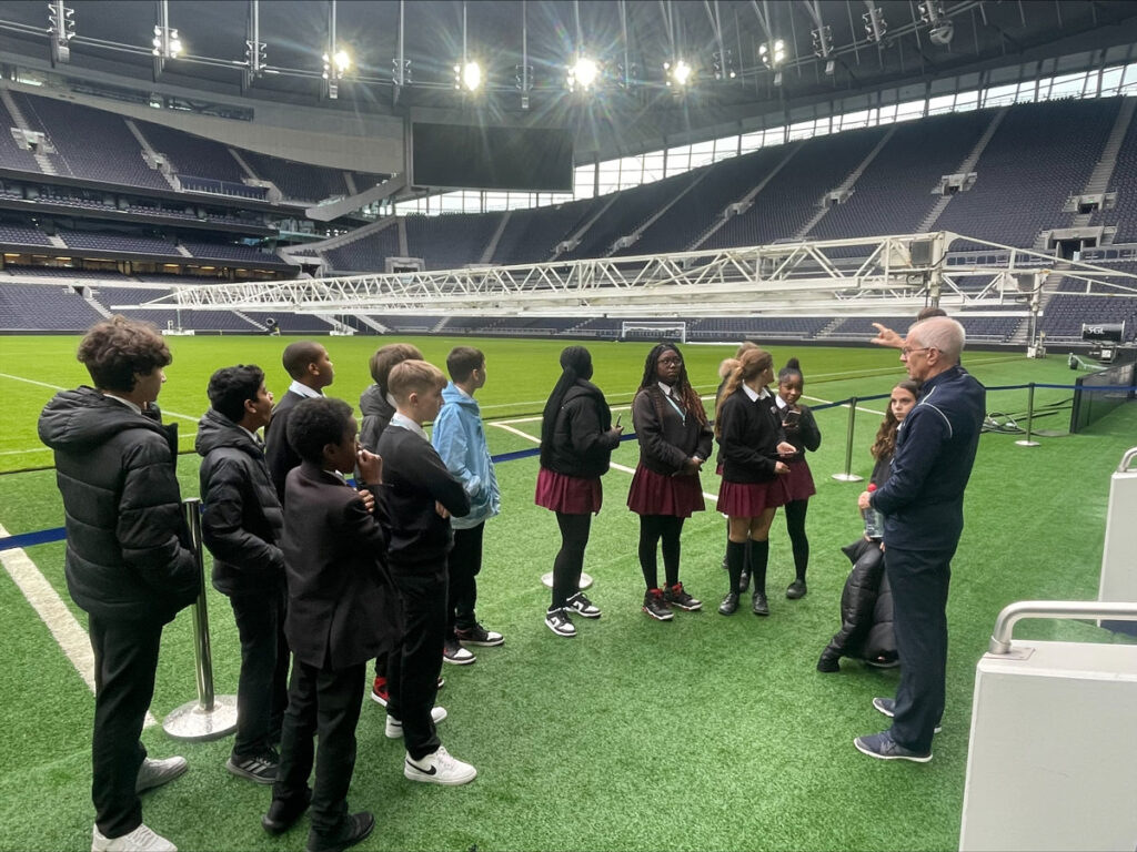 EBS Students standing on the pitch at Tottenham Hotspur