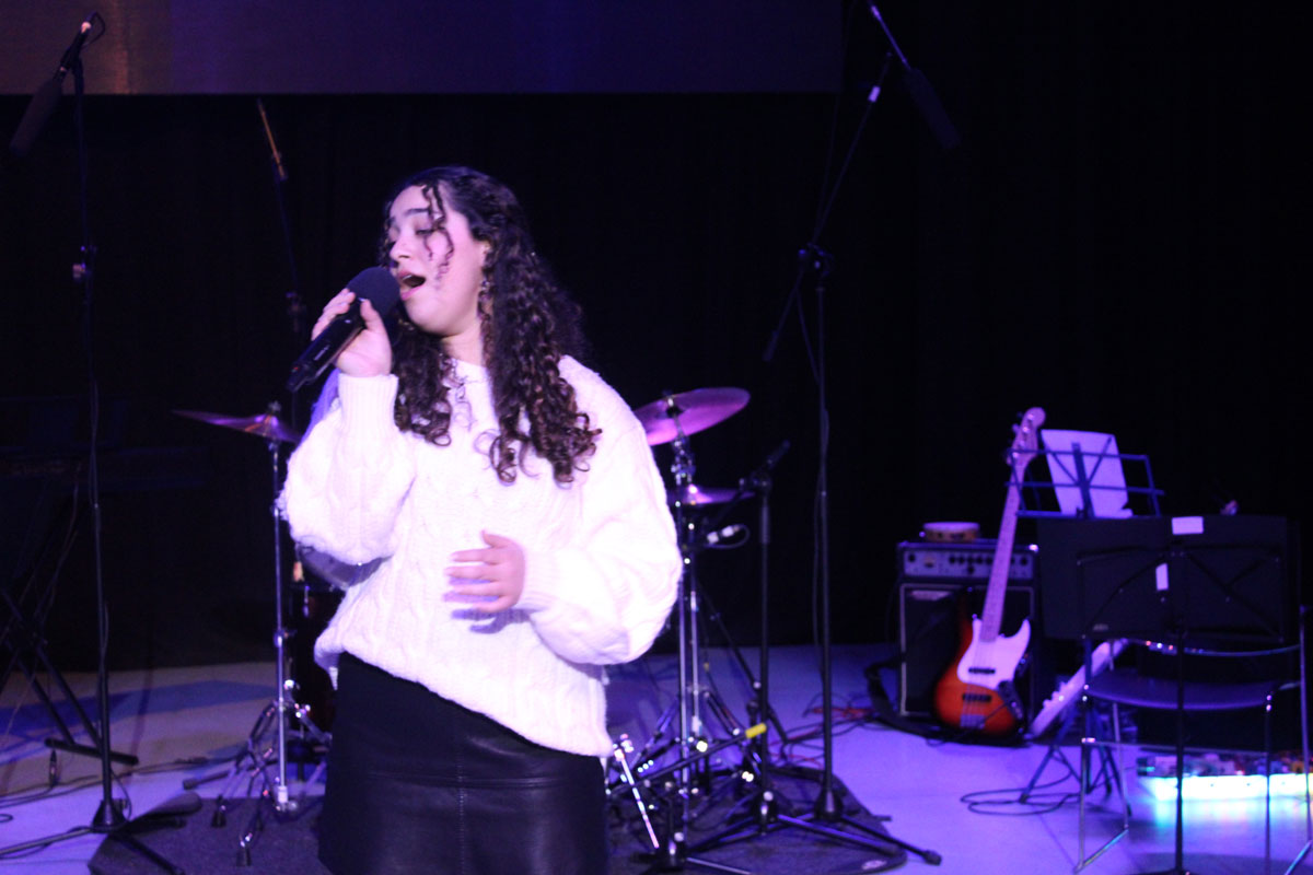 A female student singing at the East Barnet School Winter Concert.