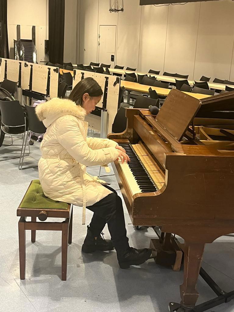 a chinese visiting student playing piano