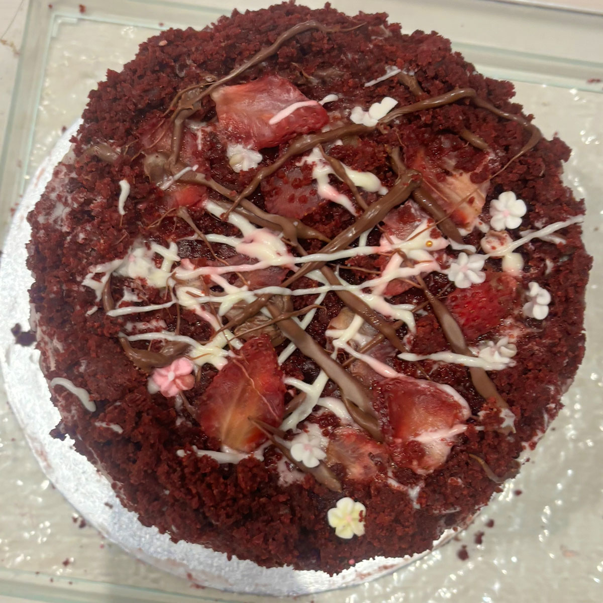 a chocolate cake with strawberries and drizzle for the ebs cake competition