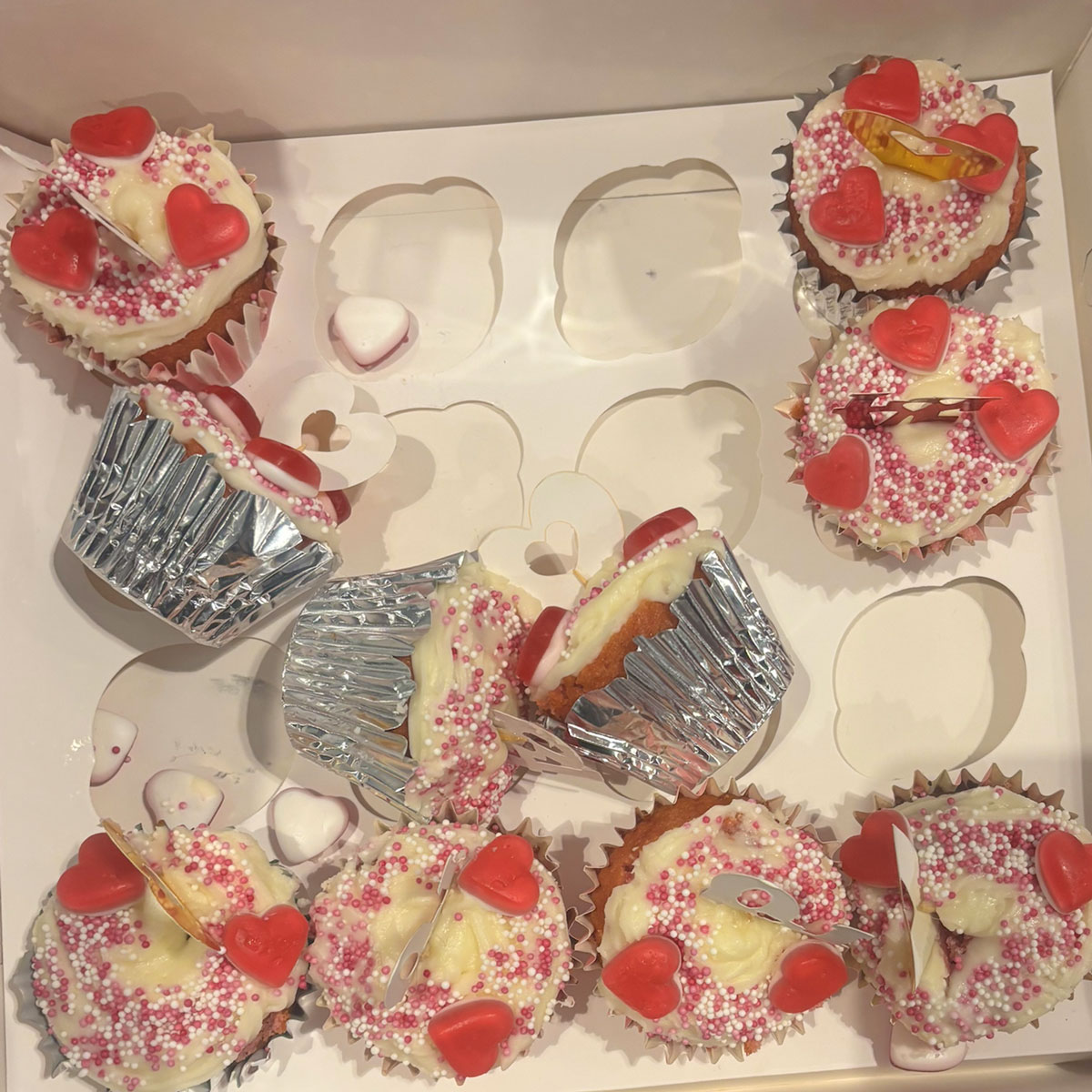 a set of demolished cup cakes with red hearts for the ebs cake competition