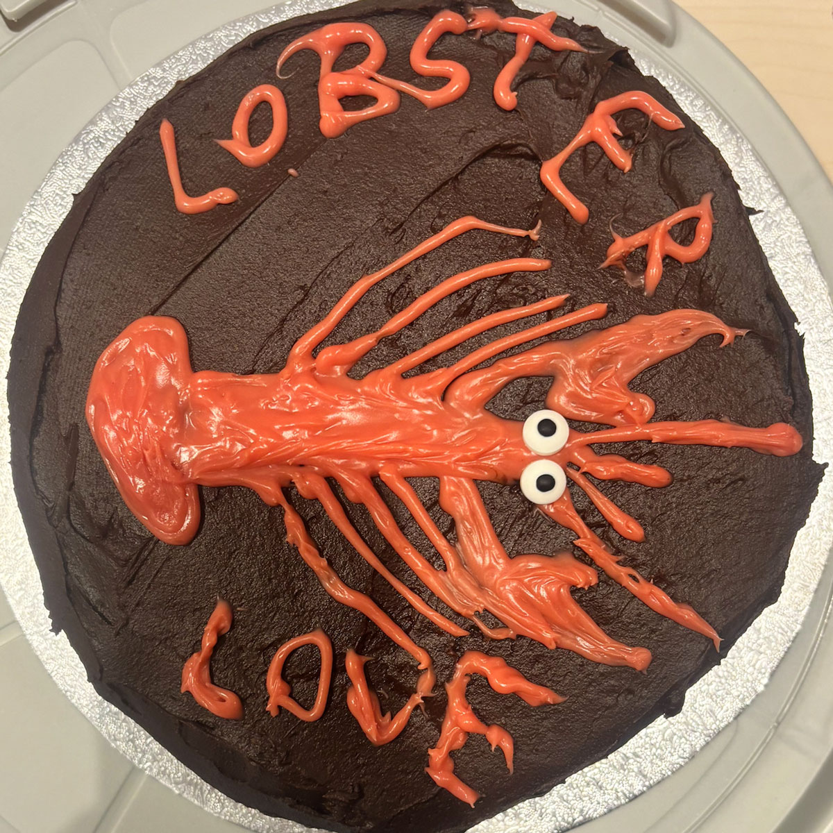 a cake with a red lobster on top that says lobster love for the ebs cake competition