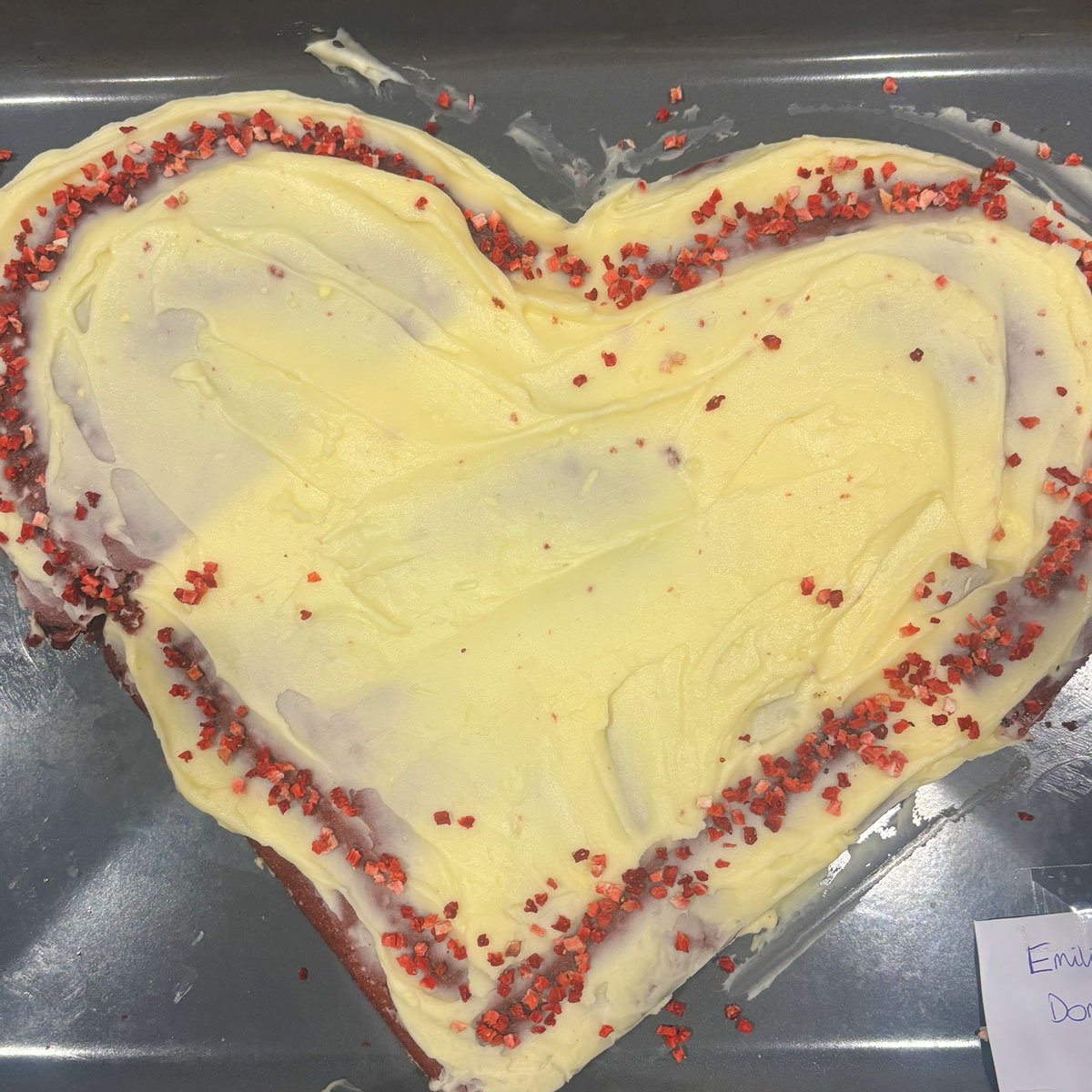 a yellow heart shaped cake with a red border for the ebs cake competition