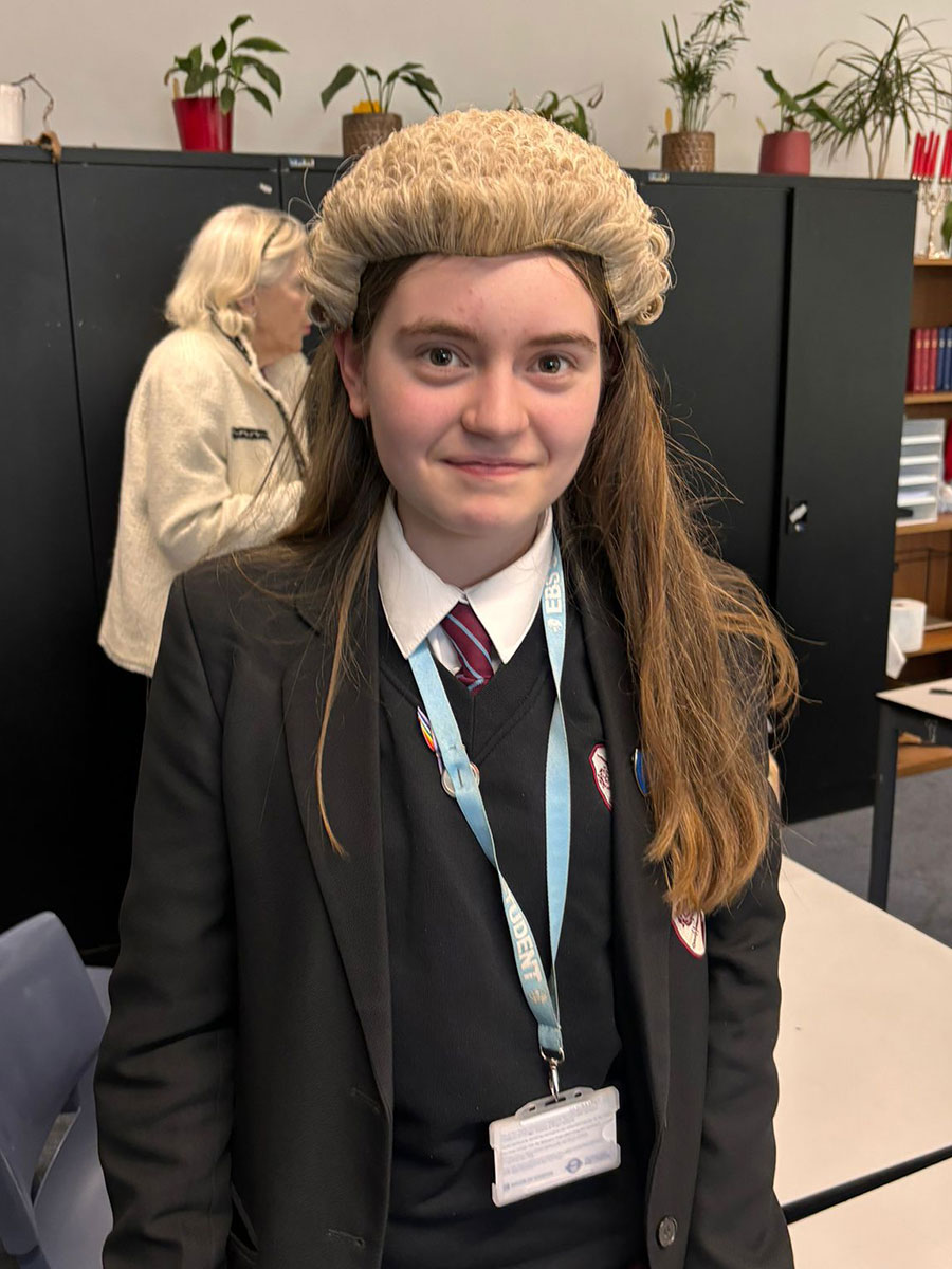 an ebs student wearing a judges wig whilst preparing for a mock trial