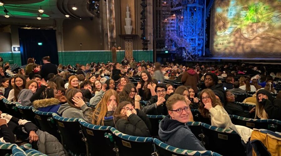 students in their seats in the theatre to see wicked